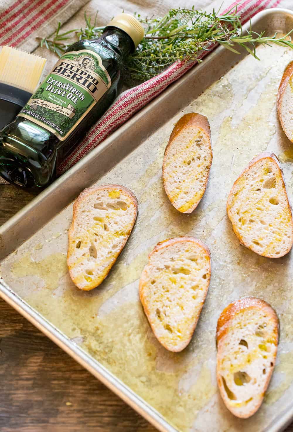 Toasting baguette slices in the oven for goat cheese mushroom toasts